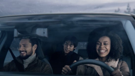 Three passengers riding in a vehicle and smiling | Wood Nissan of Lee's Summit in Lee's Summit MO