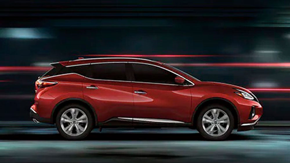2023 Nissan Murano shown in profile driving down a street at night illustrating performance. | Wood Nissan of Lee's Summit in Lee's Summit MO